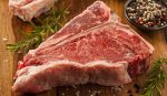 Thick Raw T-Bone Steak with Seasoning and Rosemary